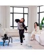 Kind tanzt, während MagicDog EDU Roboterhund im modernen Wohnzimmer zuschaut